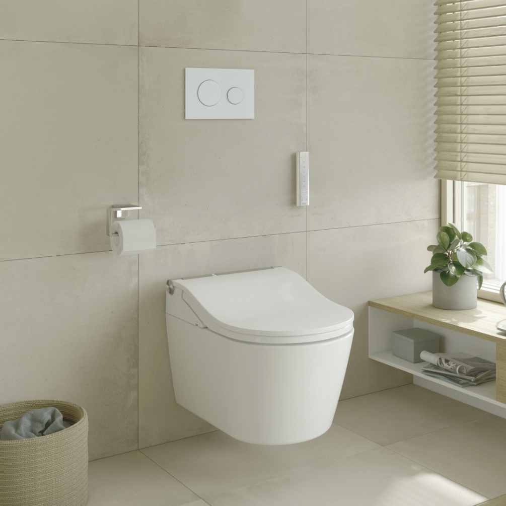 Lifestyle image of the TOTO Washlet RW Rimless Wall Hung Toilet mounted on a white tiled bathroom wall with a white dual flush plate